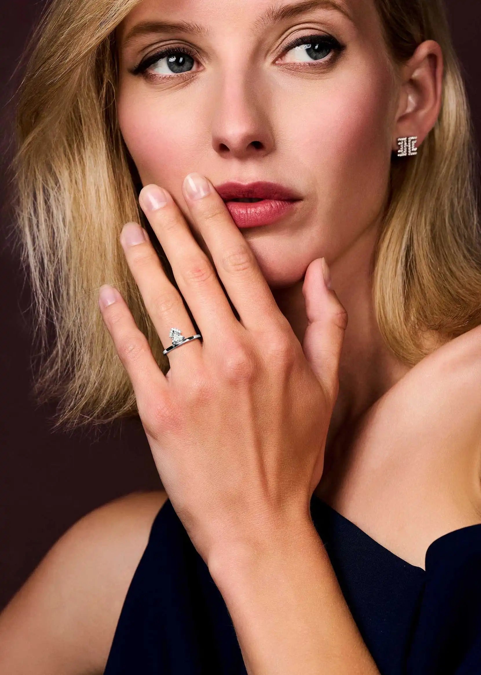 Model wearing the Victoria Gold ring, a sleek white gold band with a 0.45ct lab-grown triangle-cut diamond.