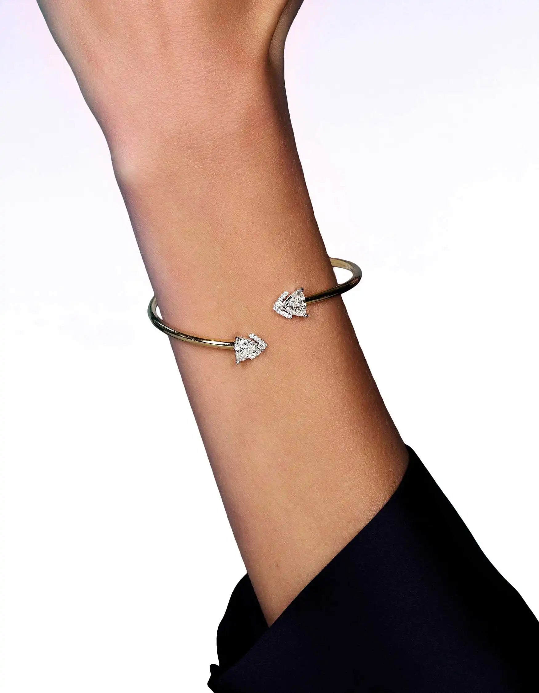 Stretched arm wearing the Victoria Duo bangle bracelet on its wrist.