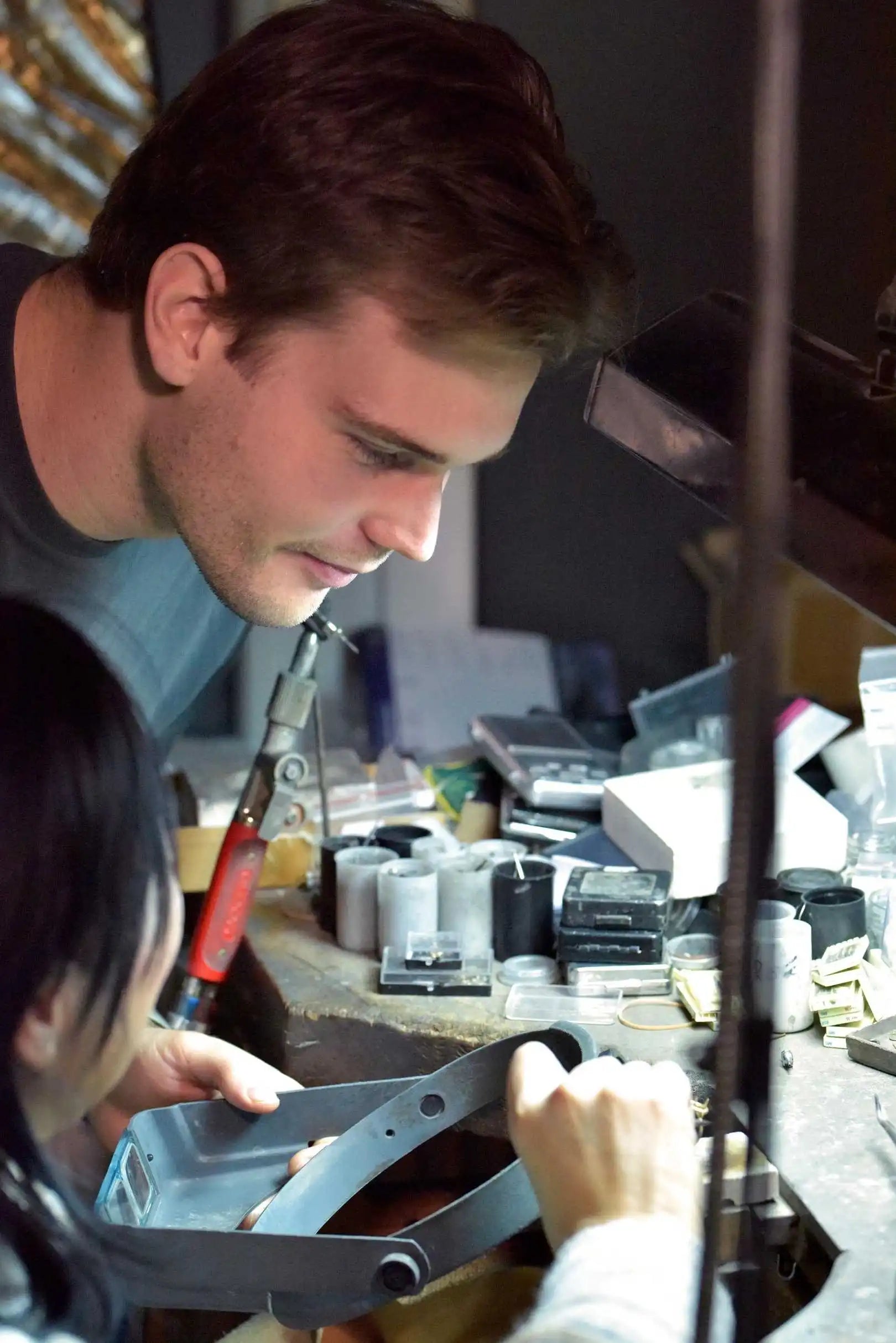Ilan Okker and a craftsman refine a ring in the Okker & Ockers atelier, surrounded by precision tools.