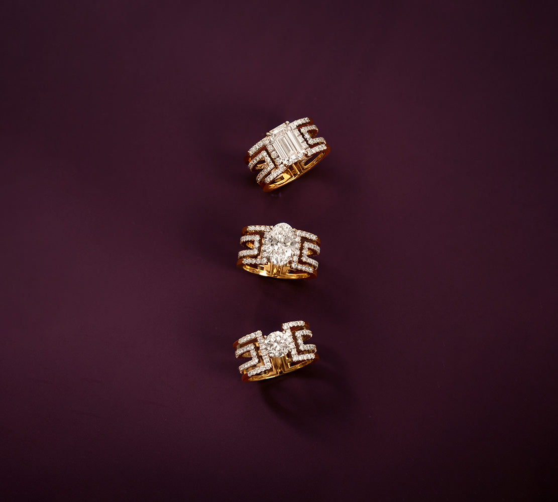 Three diamond engagement rings against a purple background.