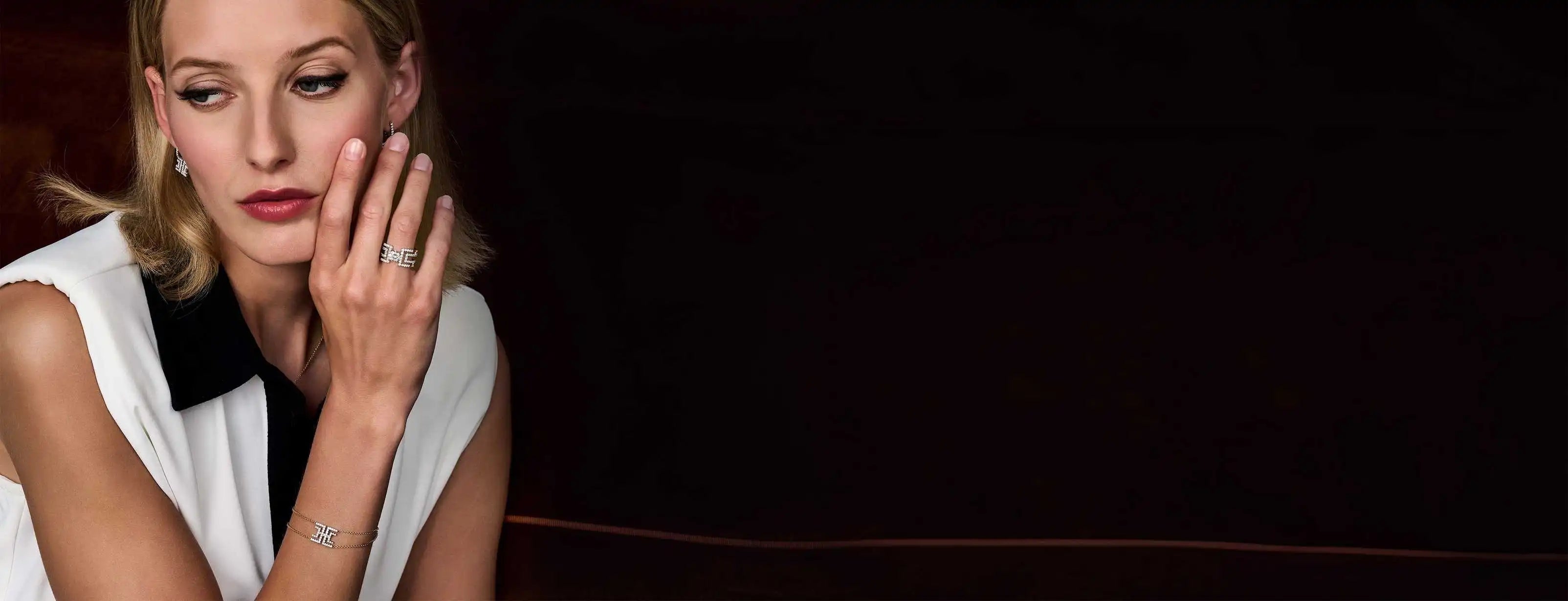 A model wearing a white shirt stacks the geometric the Entre-Deux collection pieces.