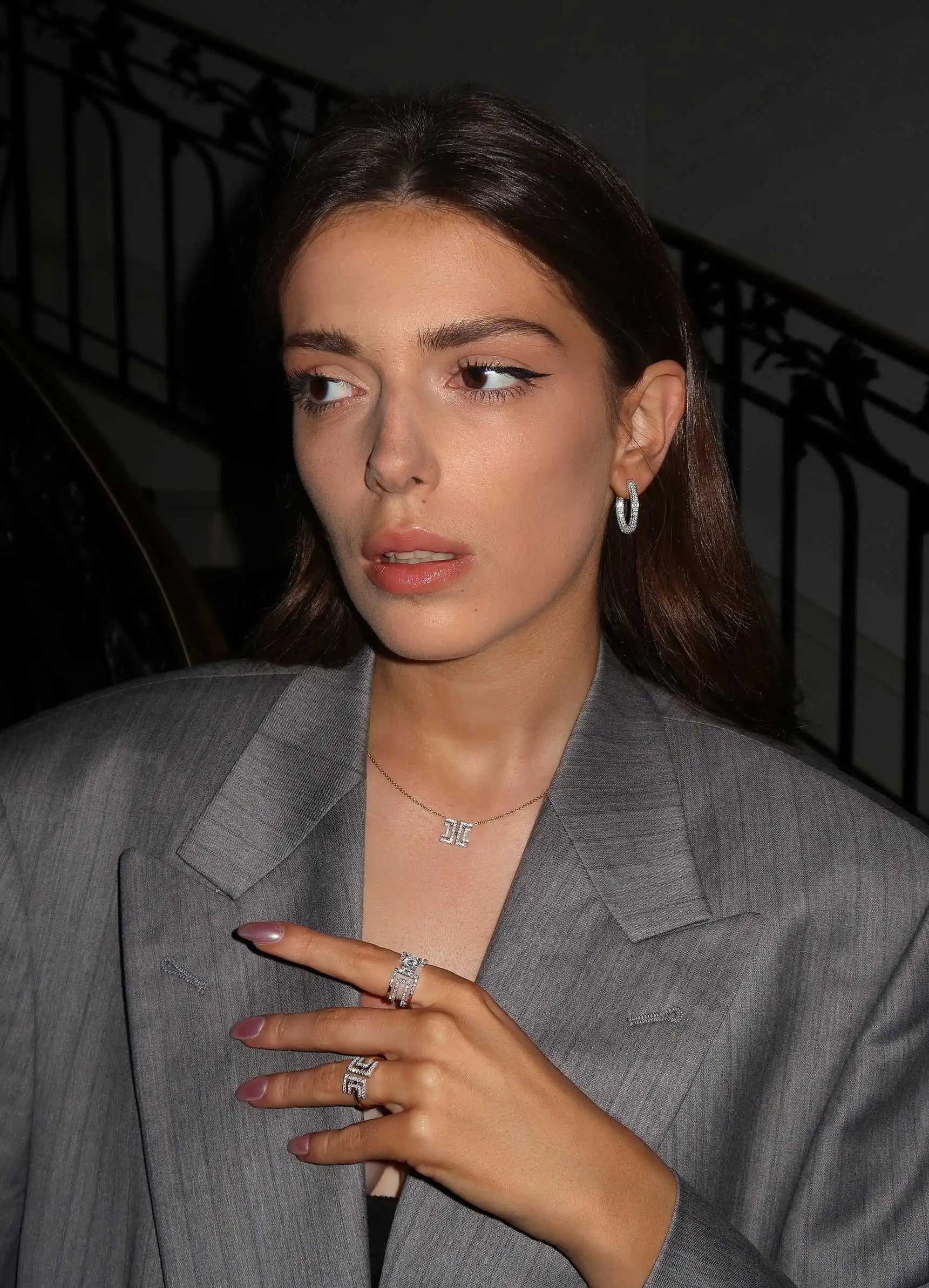 Model wearing diamond hoops with matching Entre Deux jewellery, styled with a sleek grey blazer.