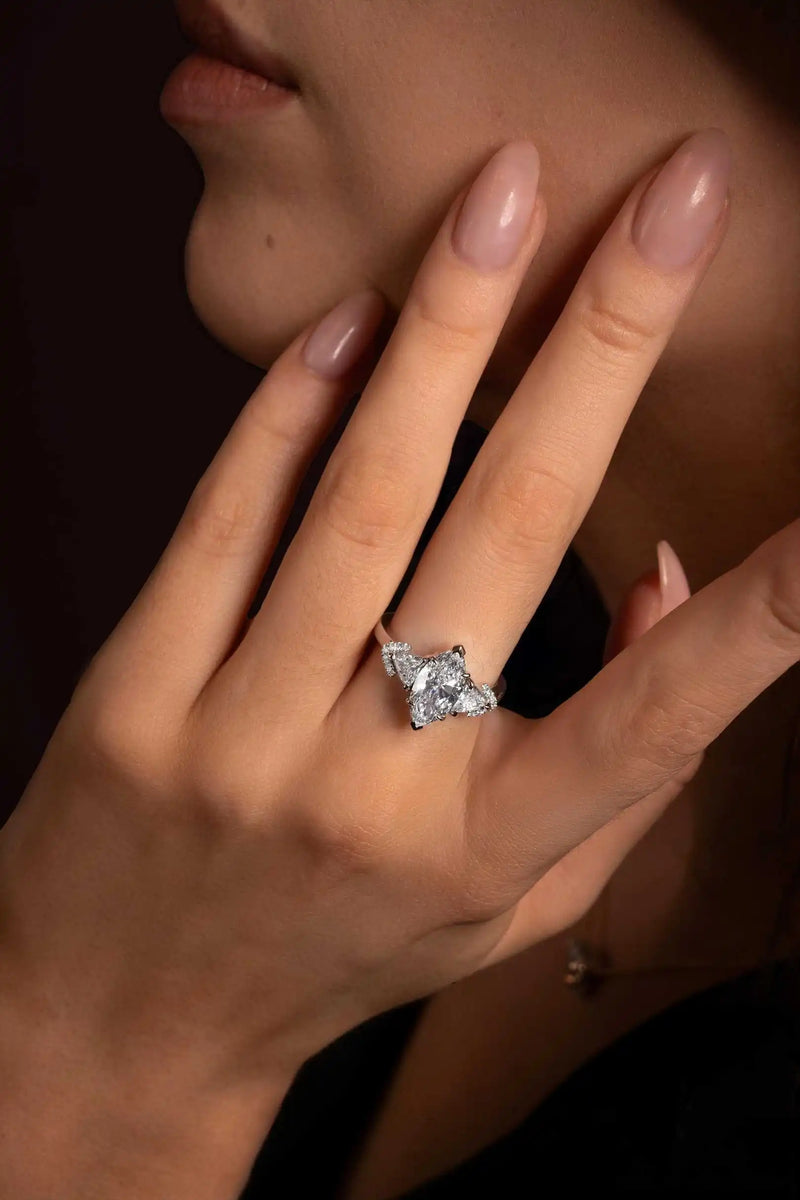 Close-up of a model’s hand wearing the Angel’s Crown ring in white gold, featuring a marquise-cut diamond with triangle sides.